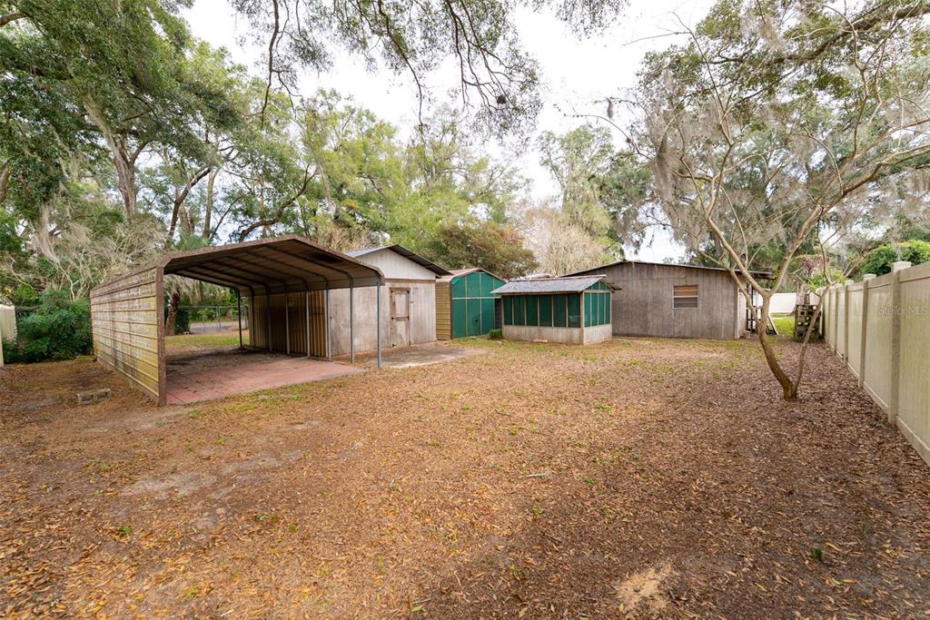 1860 Northeast 62nd Street Ocala, FL 34479 - Photo 57 of 64 a front view of a house with a yard and garage