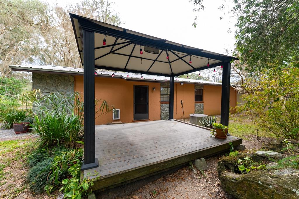 1860 Northeast 62nd Street Ocala, FL 34479 - Photo 60 of 64 a view of a house with backyard and sitting area