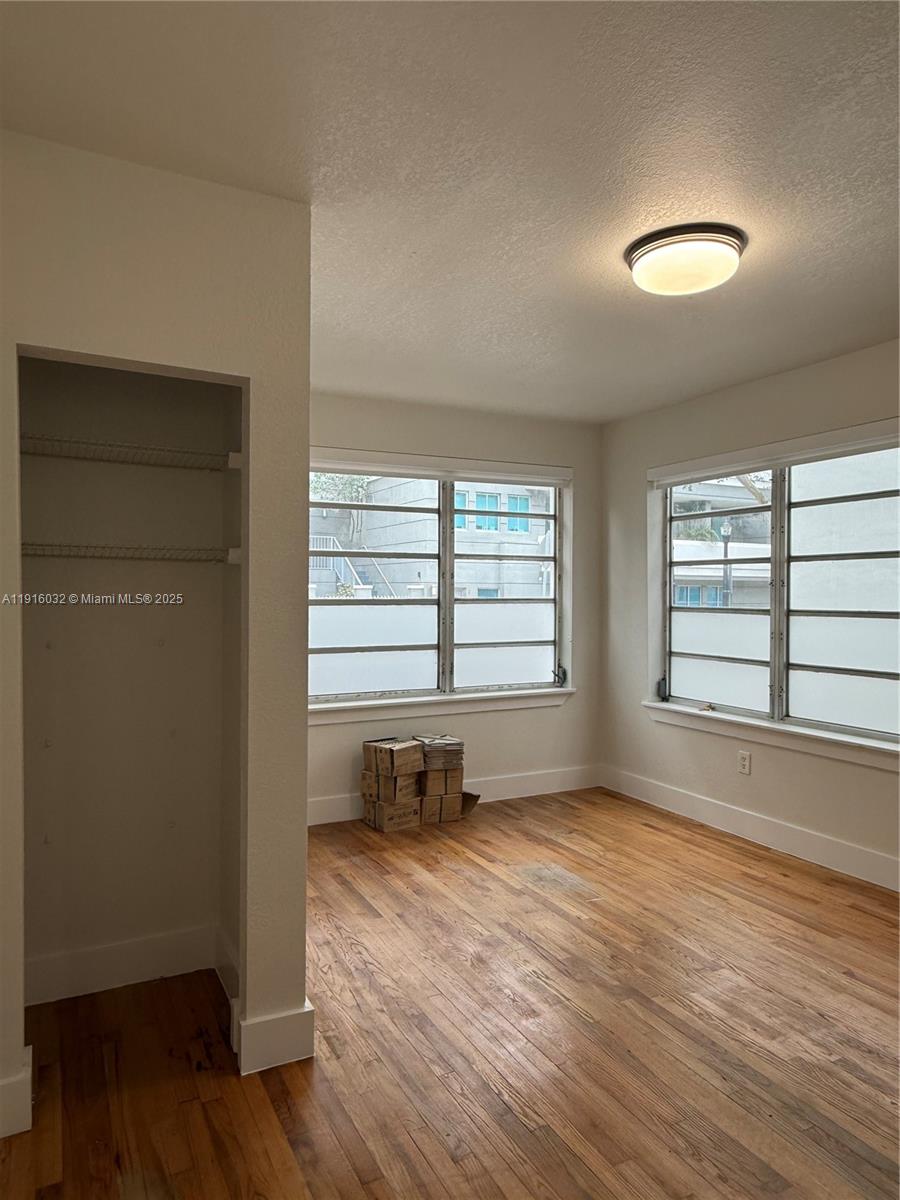 723 2nd Street, Unit 1 Miami Beach, FL 33139 - Photo 3 of 5 an empty room with wooden floor and windows