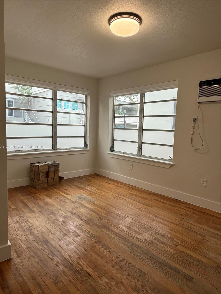 723 2nd Street, Unit 1 Miami Beach, FL 33139 - Photo 4 of 5 an empty room with wooden floor and windows