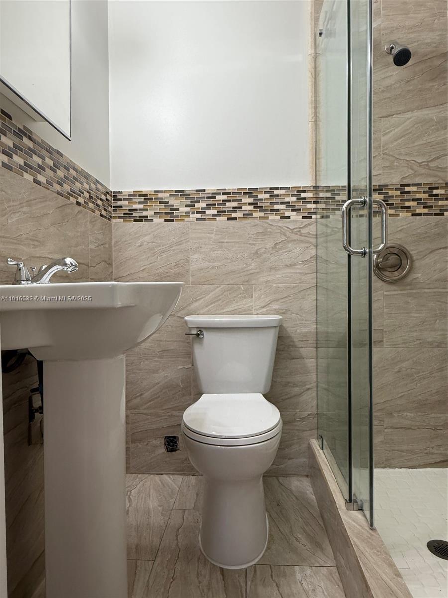 723 2nd Street, Unit 1 Miami Beach, FL 33139 - Photo 5 of 5 a bathroom with a toilet and a shower