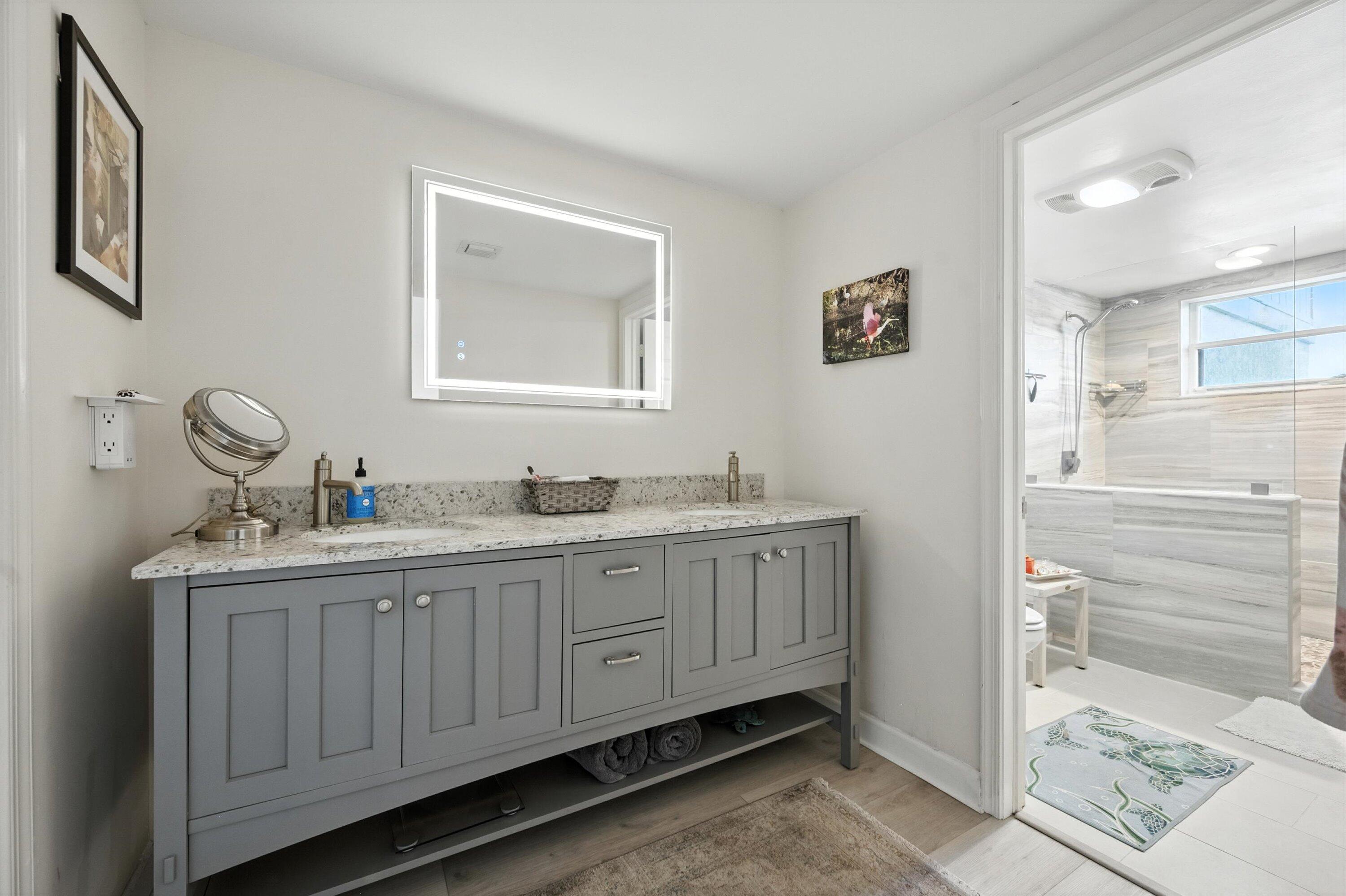 16913 Waterbend Drive, Unit 165 Jupiter, FL 33477 - Photo 17 of 39 a bathroom with a sink and a mirror