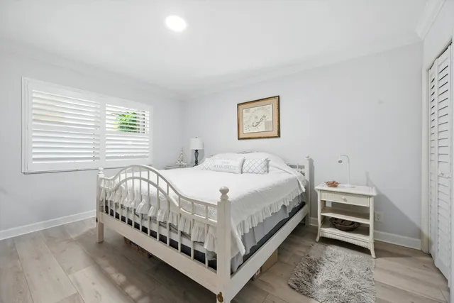 a bed sitting in a bedroom next to a window