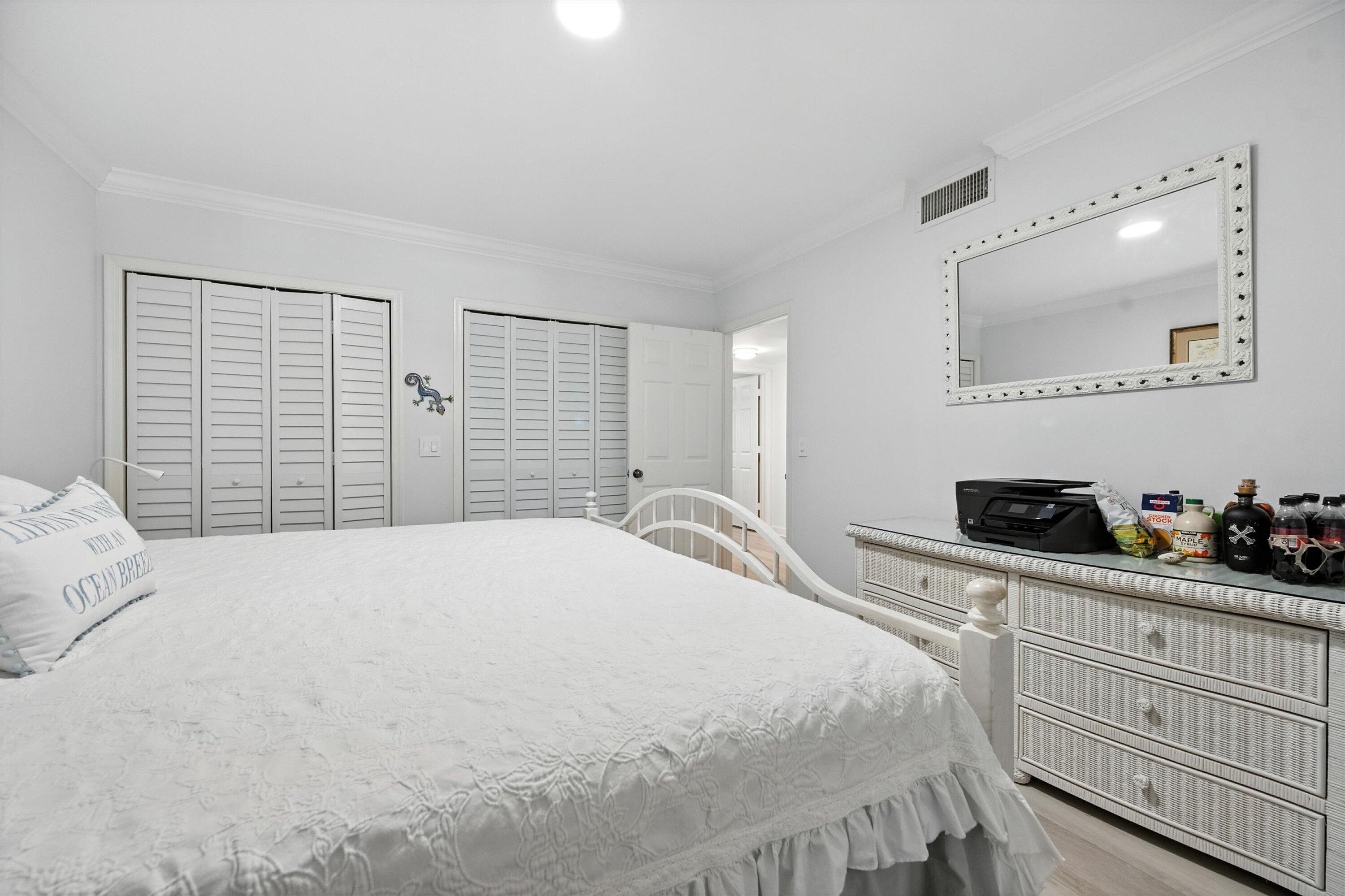 16913 Waterbend Drive, Unit 165 Jupiter, FL 33477 - Photo 19 of 39 a bedroom with a bed and a dresser