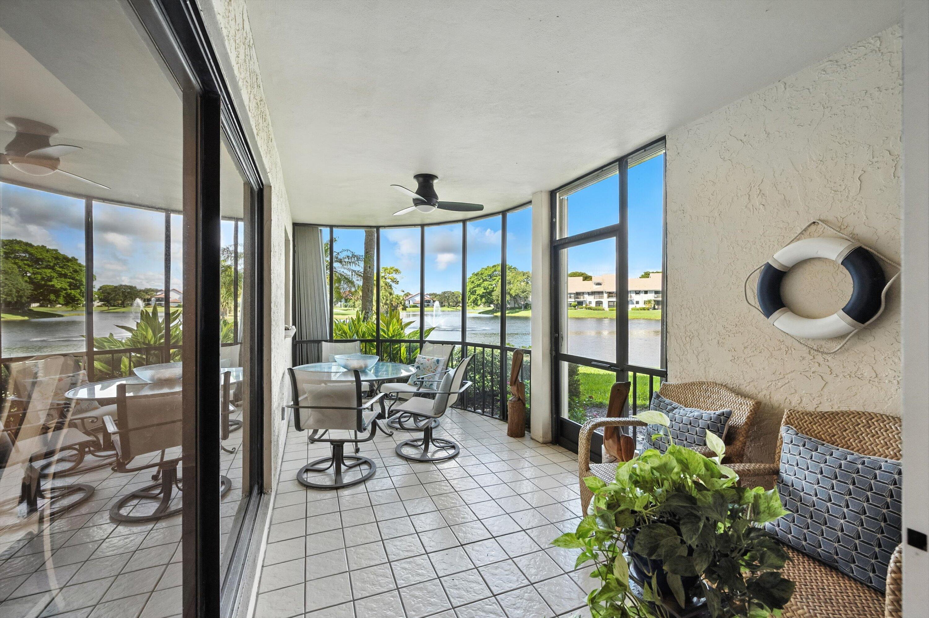 16913 Waterbend Drive, Unit 165 Jupiter, FL 33477 - Photo 24 of 39 a living room with furniture and a floor to ceiling window