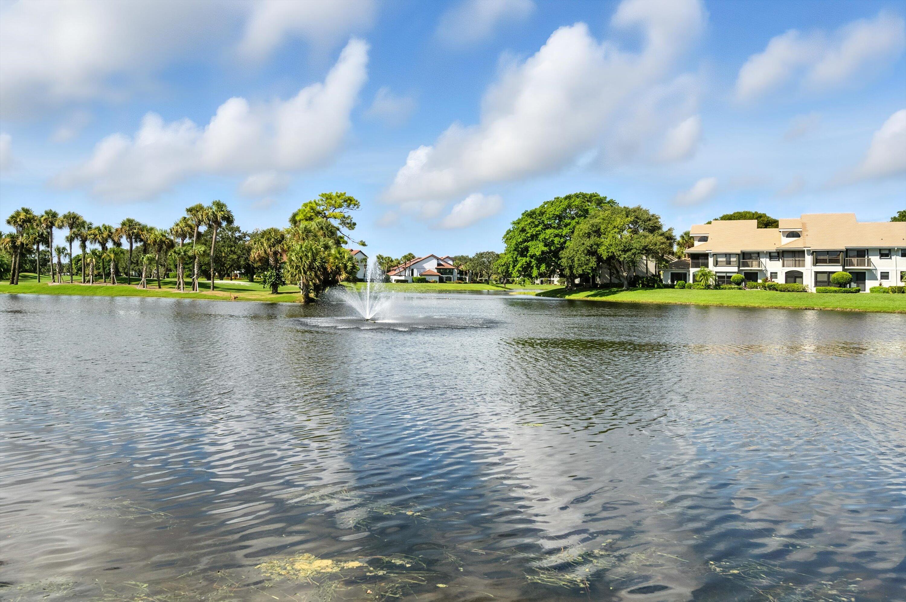 16913 Waterbend Drive, Unit 165 Jupiter, FL 33477 - Photo 29 of 39 a view of a lake with houses in the back