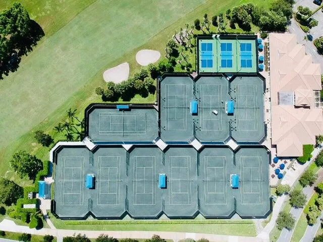 an aerial view of a house with a yard and parking spaces