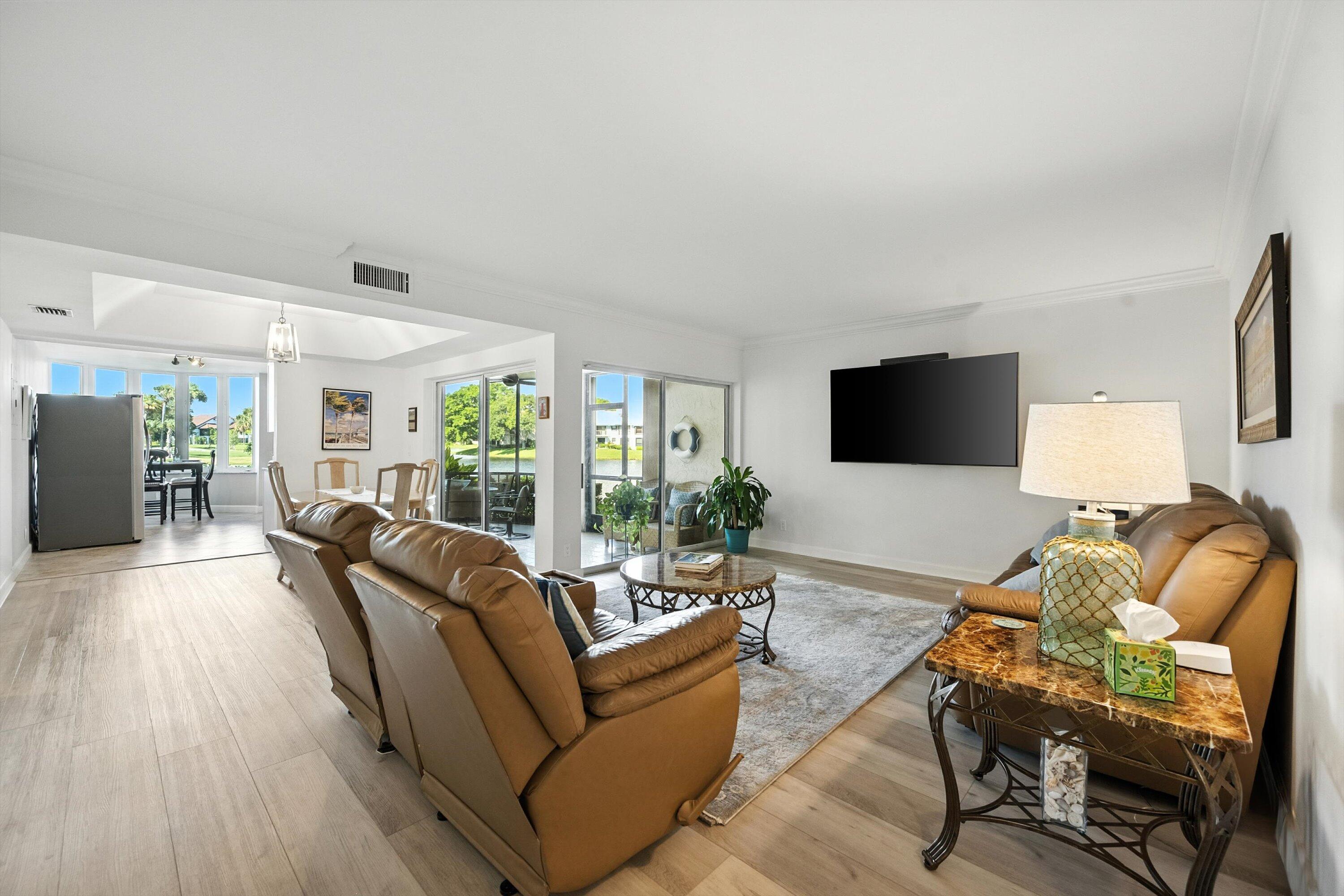 16913 Waterbend Drive, Unit 165 Jupiter, FL 33477 - Photo 5 of 39 a living room with furniture fireplace and flat screen tv