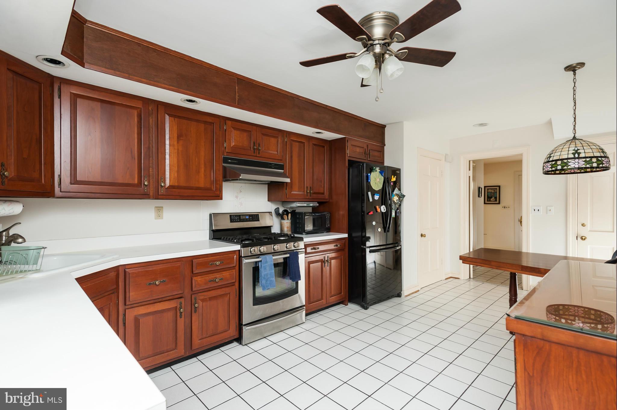 5918 Charlesmead Road Baltimore, MD 21212 - Photo 11 of 27 a kitchen with stainless steel appliances granite countertop a sink and cabinets