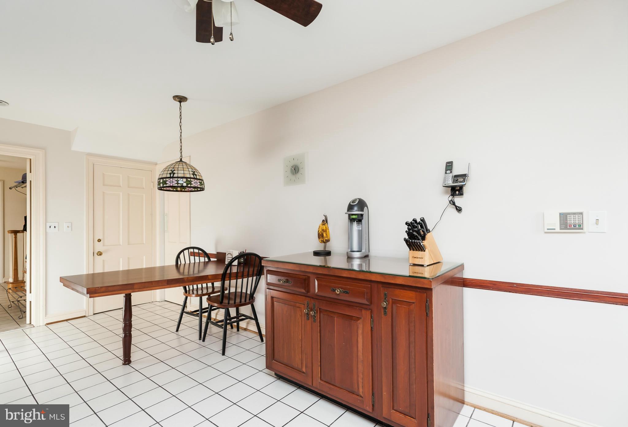 5918 Charlesmead Road Baltimore, MD 21212 - Photo 13 of 27 a room with a table chairs and a chandelier