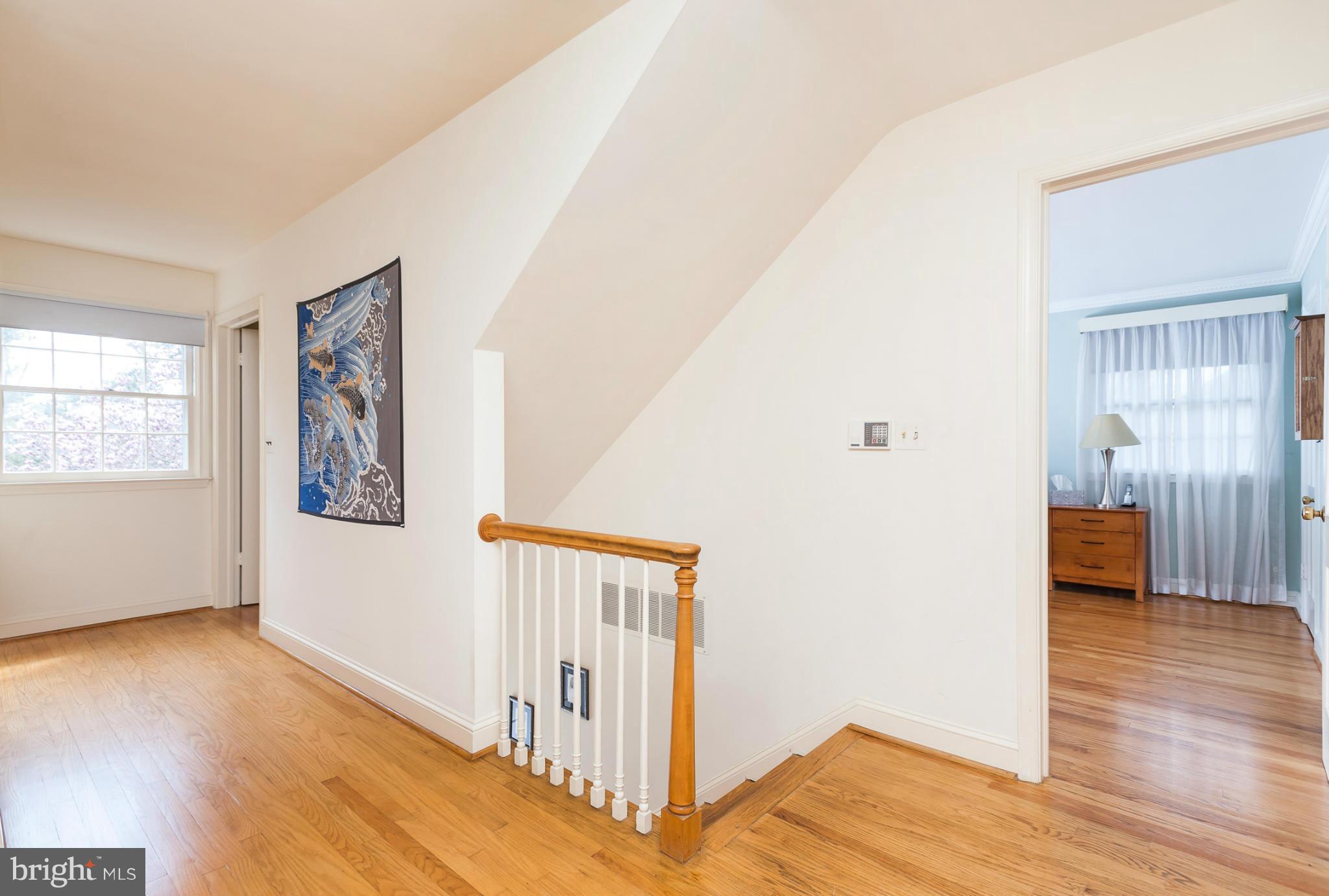 5918 Charlesmead Road Baltimore, MD 21212 - Photo 24 of 27 a view of hallway with wooden floor and stairs