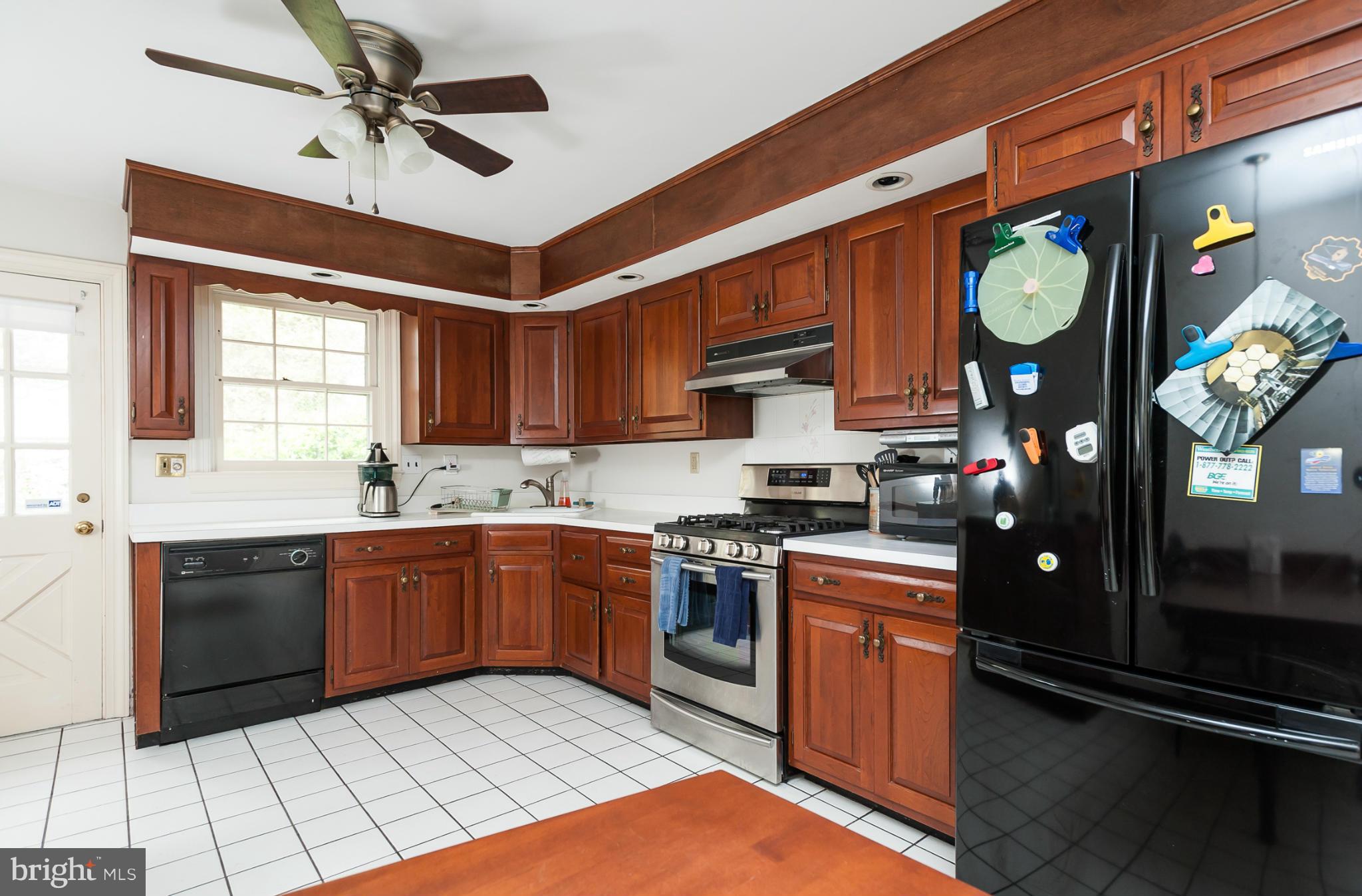 5918 Charlesmead Road Baltimore, MD 21212 - Photo 10 of 27 a kitchen with stainless steel appliances granite countertop a stove a sink and a refrigerator