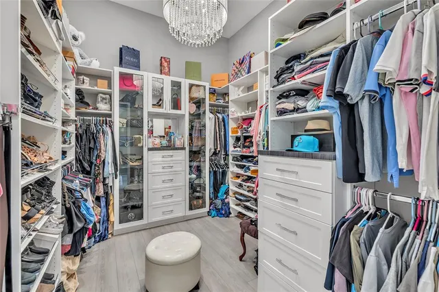 a view of a patio with couches chairs and floor to ceiling window next to a yard