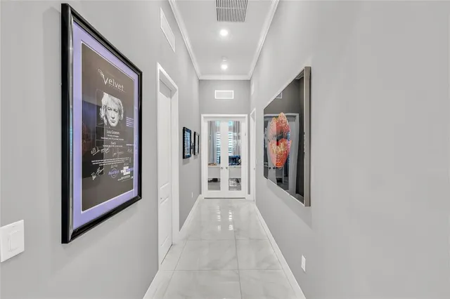 a large white kitchen with a large island in the center windows and furniture