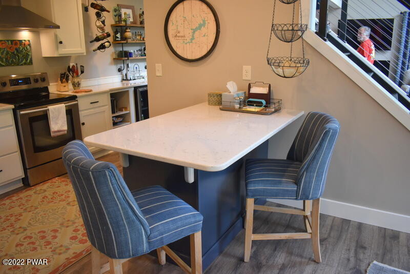 549 Finn Swamp Road Lakeville, PA 18438 - Photo 6 of 35 a kitchen with a table chairs a stove and a microwave