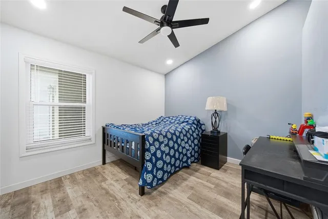 a bedroom with a bed and a table