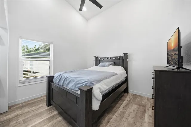 a bedroom with a bed and a flat tv screen on a dresser