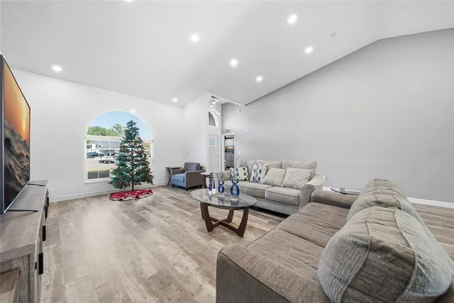 a living room with furniture gym equipment and a large window