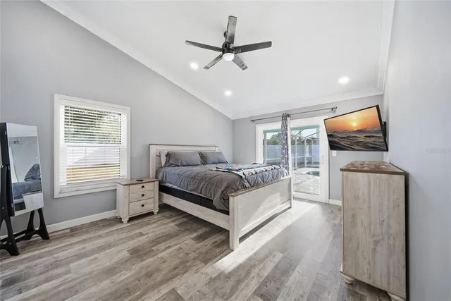 a bedroom with a bed window and a flat screen tv