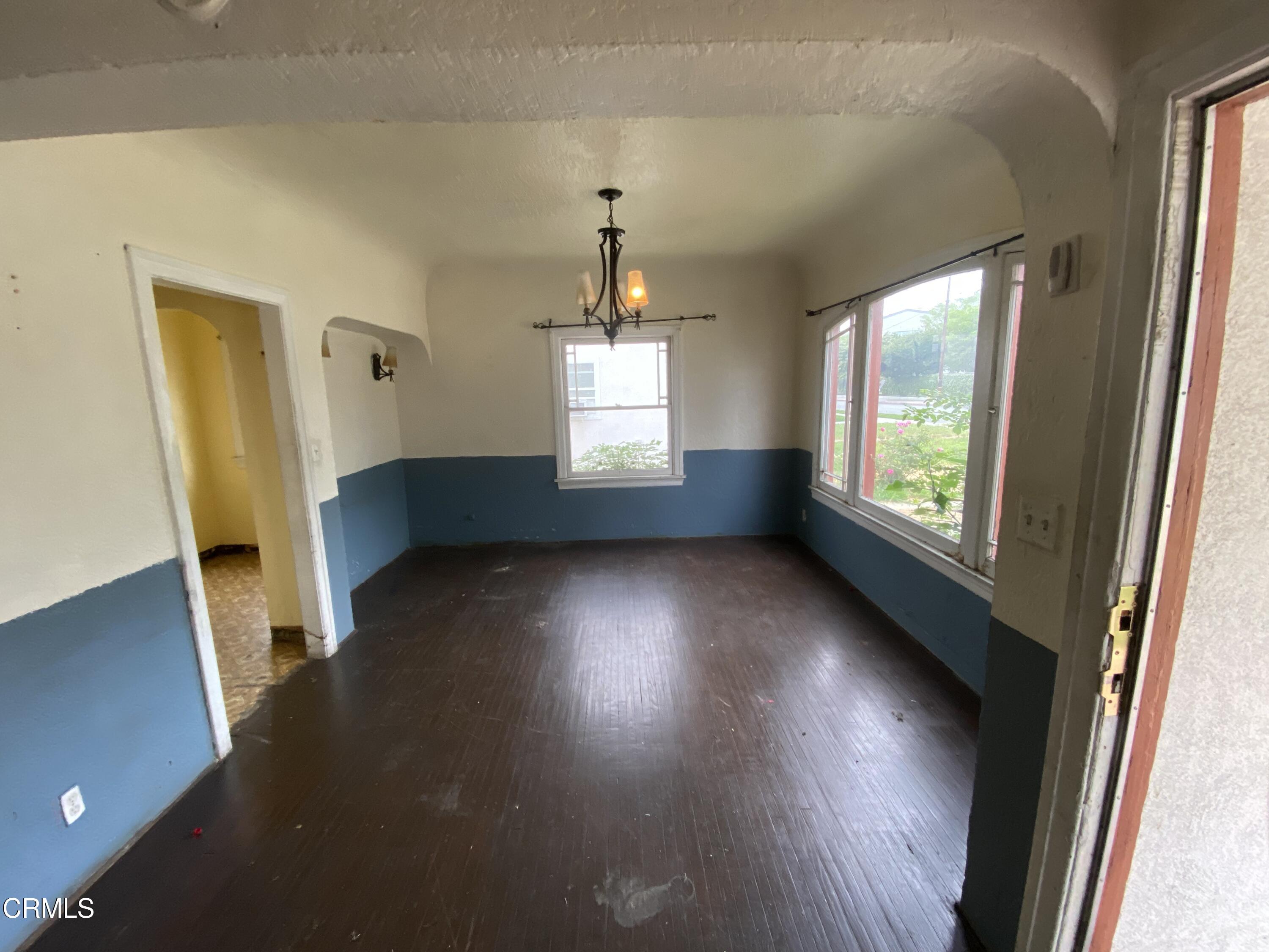 11210 Oak Street El Monte, CA 91731 - Photo 3 of 15 an empty room with wooden floor and windows