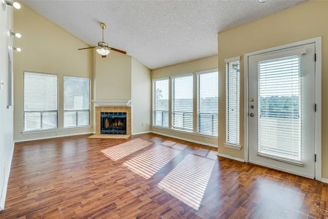 a view of an empty room with exposed radiator and fireplace