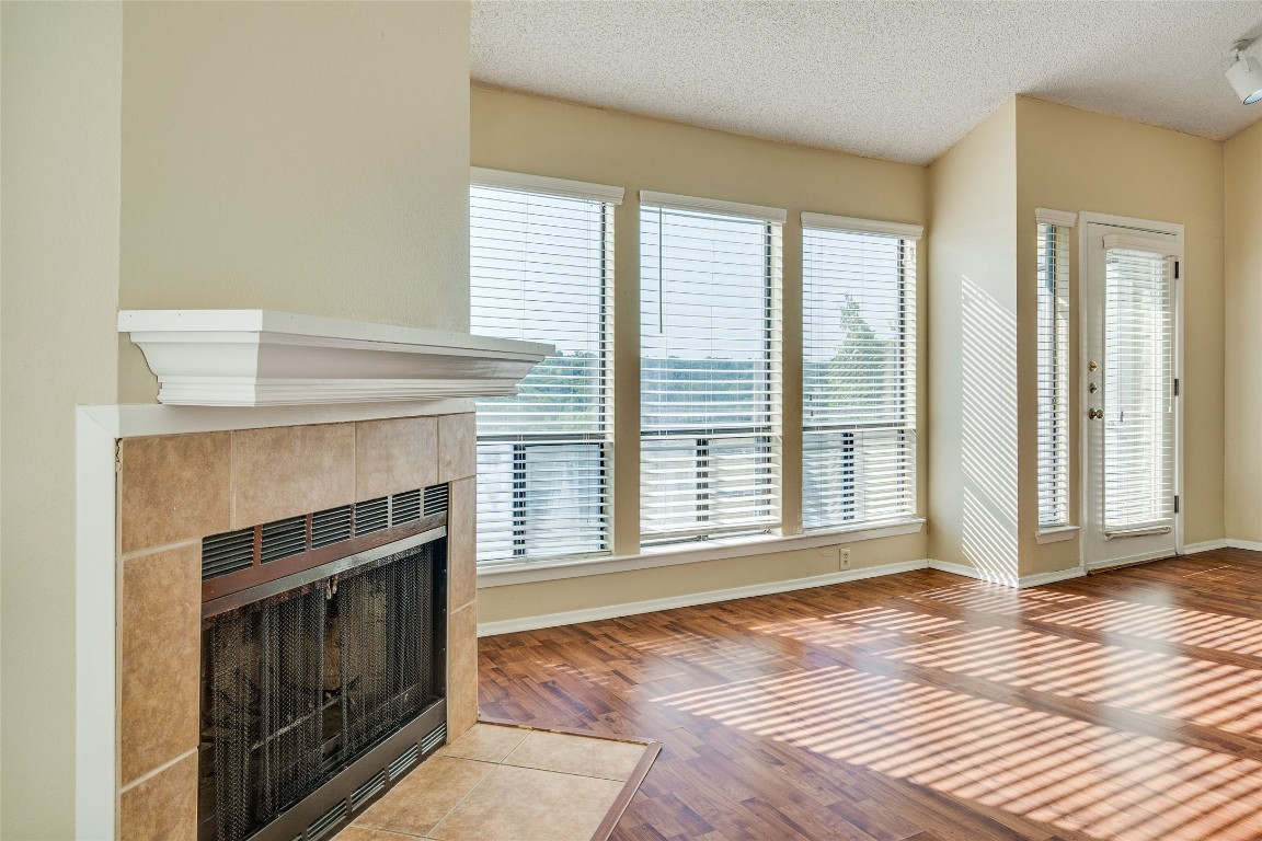 2612 San Pedro Street, Unit 222 Austin, TX 78705 - Photo 13 of 37 a view of an empty room with wooden floor fireplace and a window