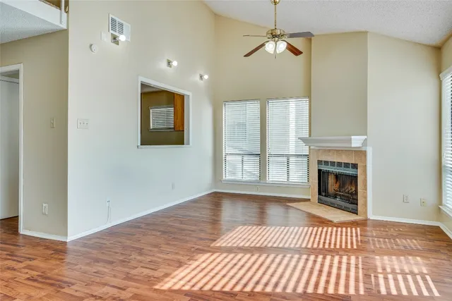 a view of a room with wooden floor and a bathroom