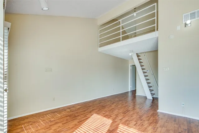a view of an empty room with a fireplace and a window