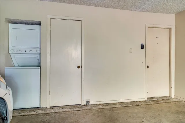 a view of an empty room with wooden floor fireplace and a window