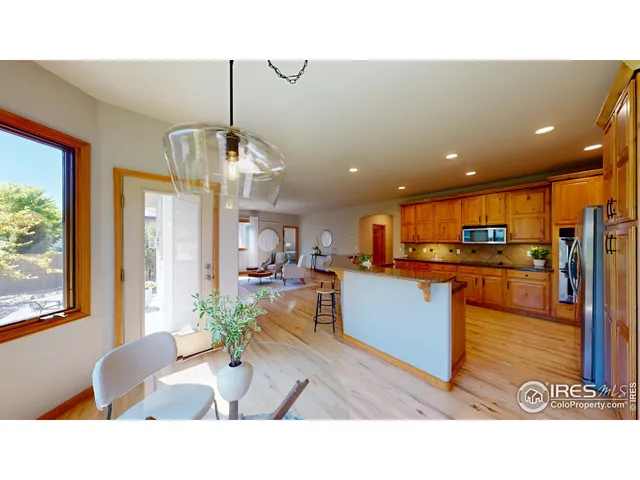 a living room with stainless steel appliances kitchen island granite countertop furniture and a view of kitchen