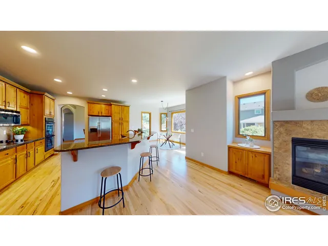 a living room with furniture a flat screen tv and a pool table