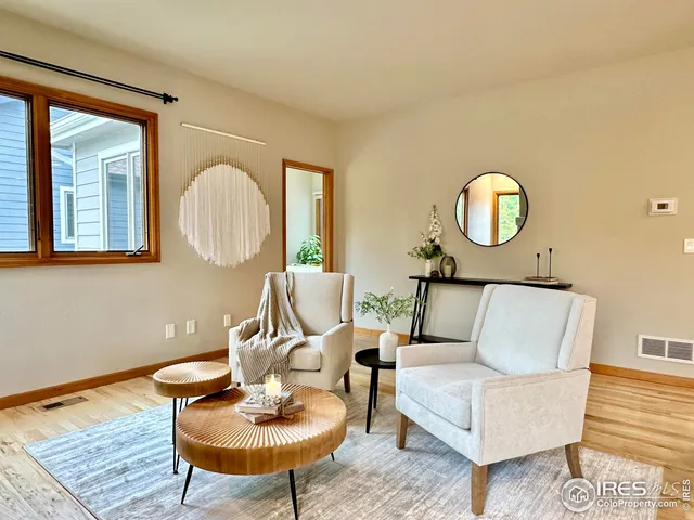 a living room with furniture a mirror and a window