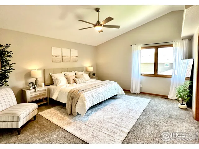 a bedroom with a bed couch and a potted plant