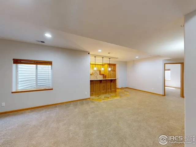 an empty room with a empty space and windows