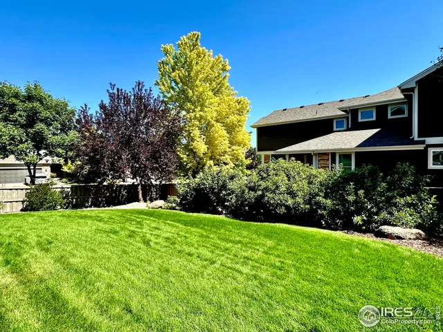 a view of a backyard with sitting area and garden