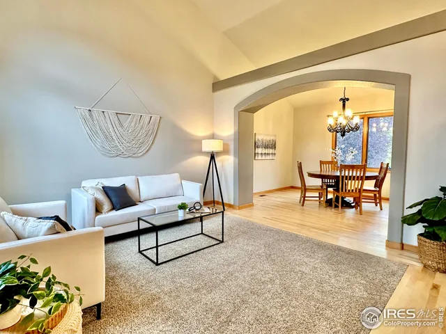 a living room with furniture and wooden floors