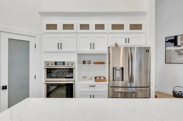 a kitchen with stainless steel appliances a refrigerator and cabinets