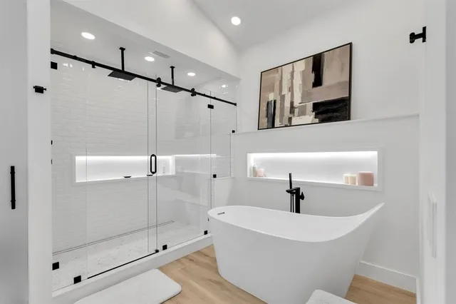 a bathroom with a bathtub and a shower