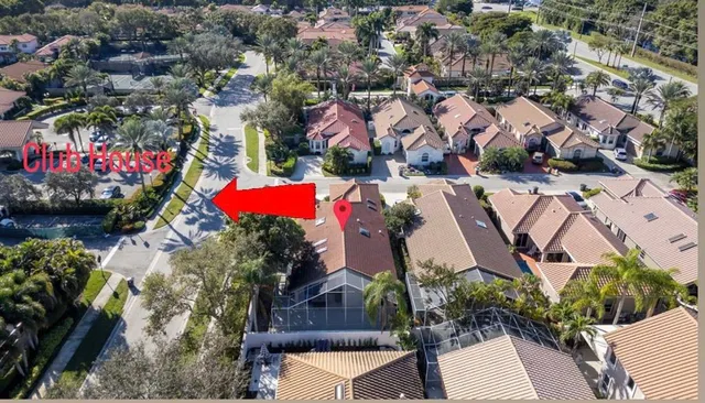 an aerial view of a house with a yard and lake view