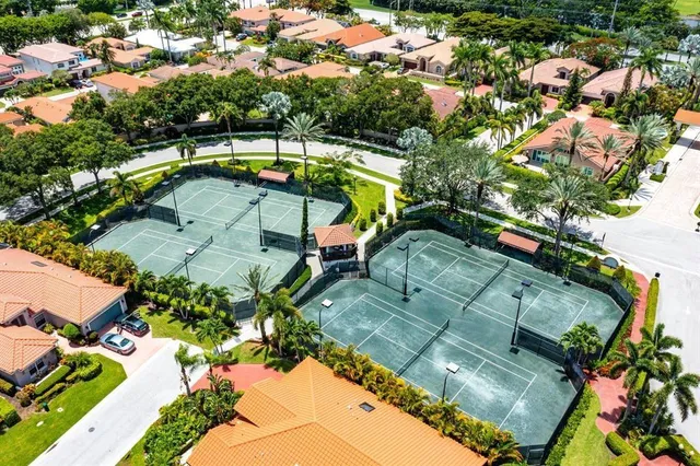 an aerial view of a house with a yard basket ball court and outdoor seating