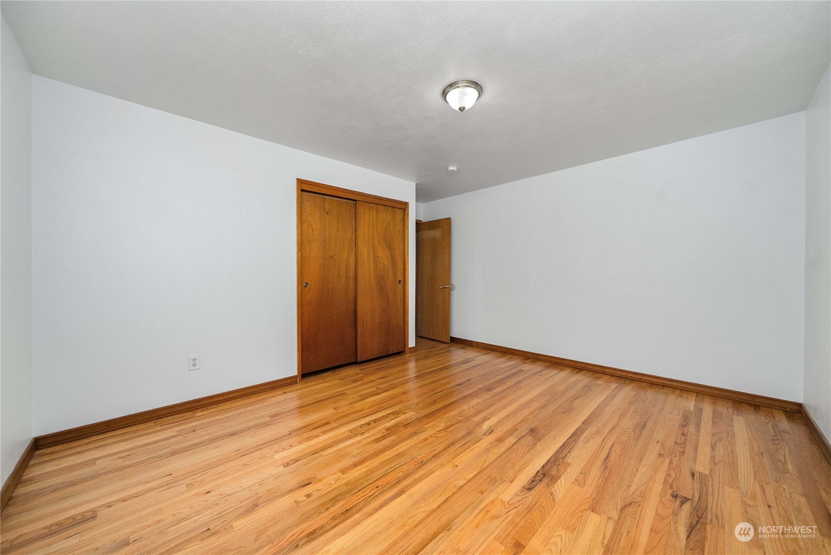 7211 Beverly Boulevard Everett, WA 98203 - Photo 12 of 36 a view of an empty room with wooden floor