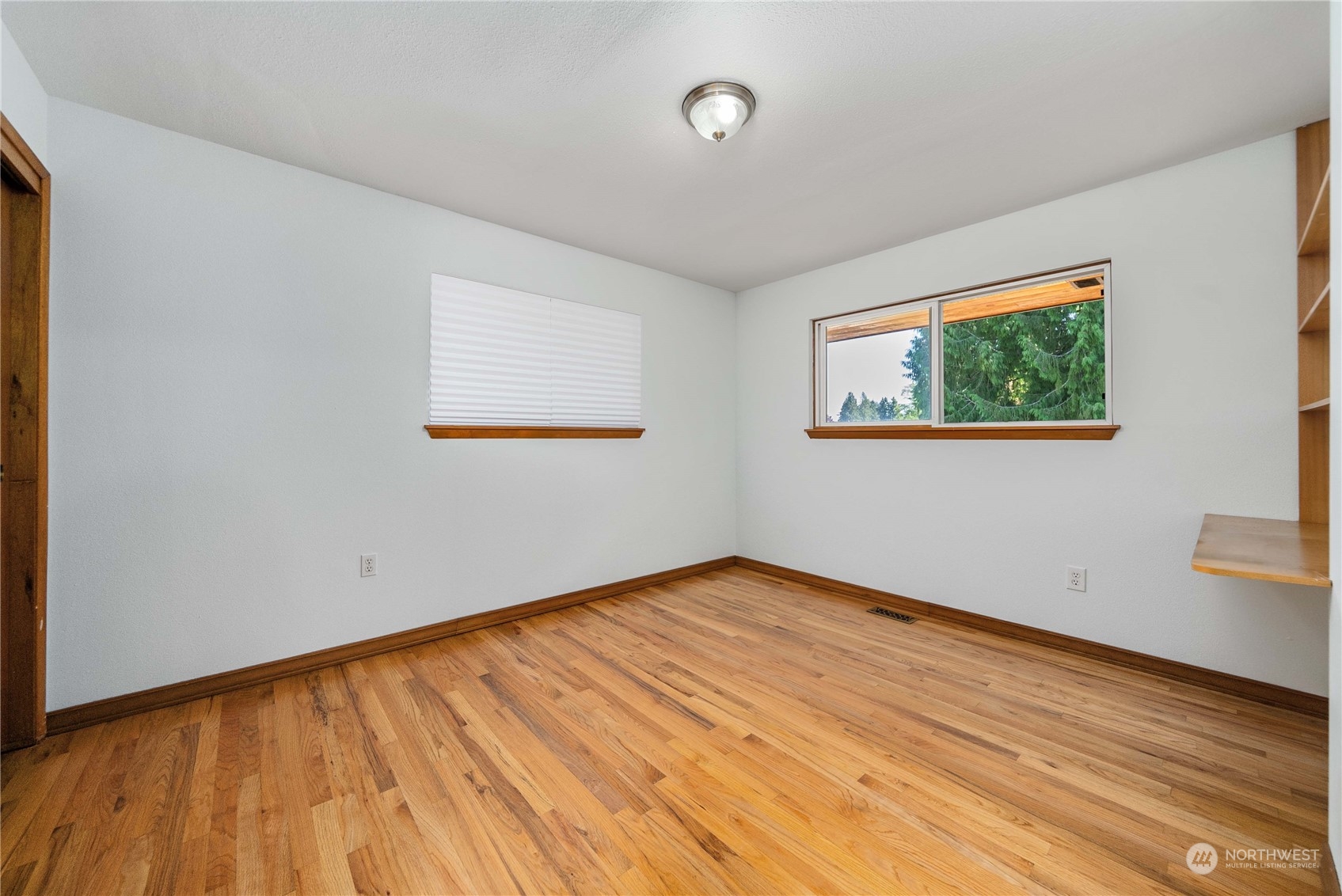 7211 Beverly Boulevard Everett, WA 98203 - Photo 14 of 36 an empty room with wooden floor and windows