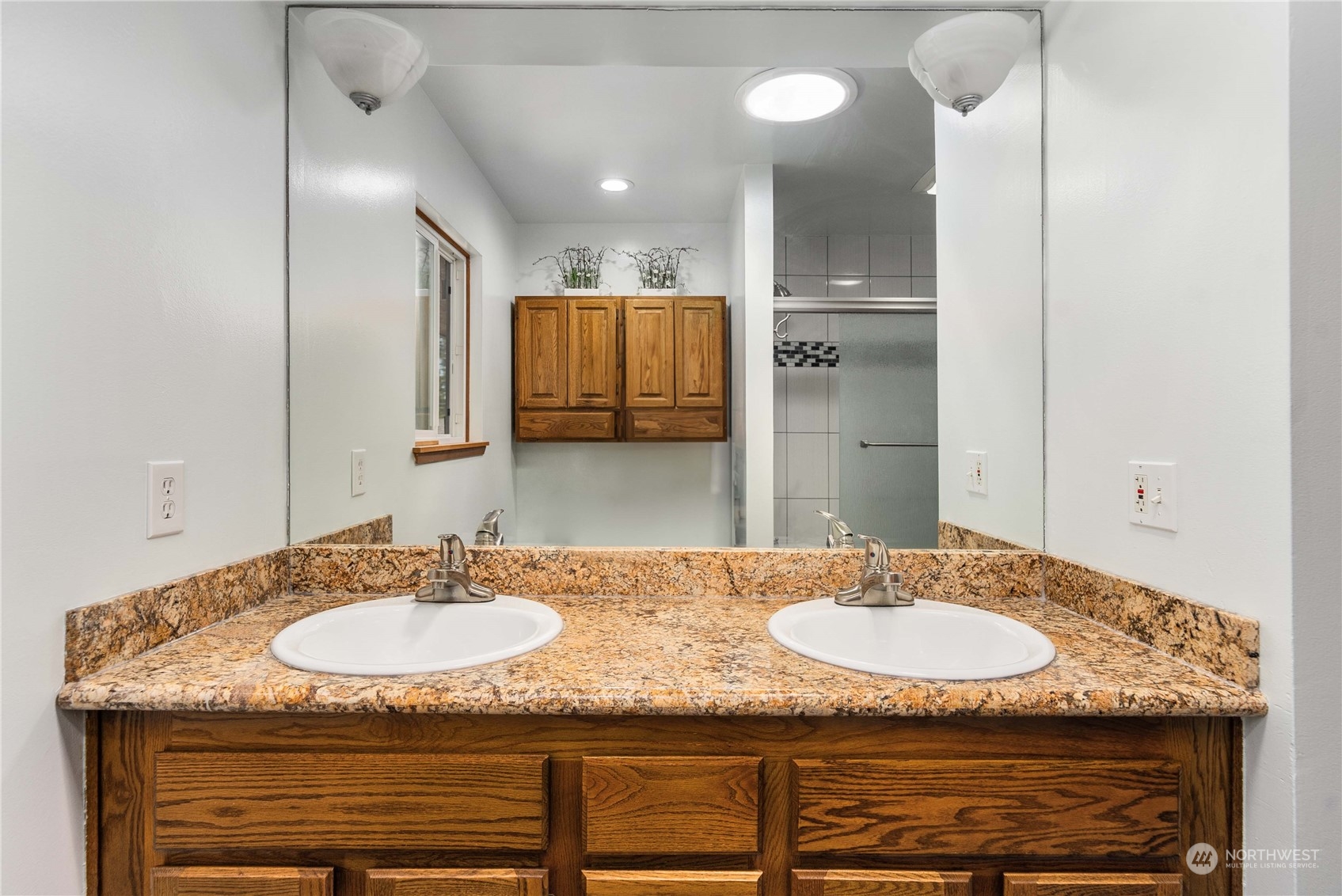 7211 Beverly Boulevard Everett, WA 98203 - Photo 16 of 36 a bathroom with a granite countertop sink and a mirror
