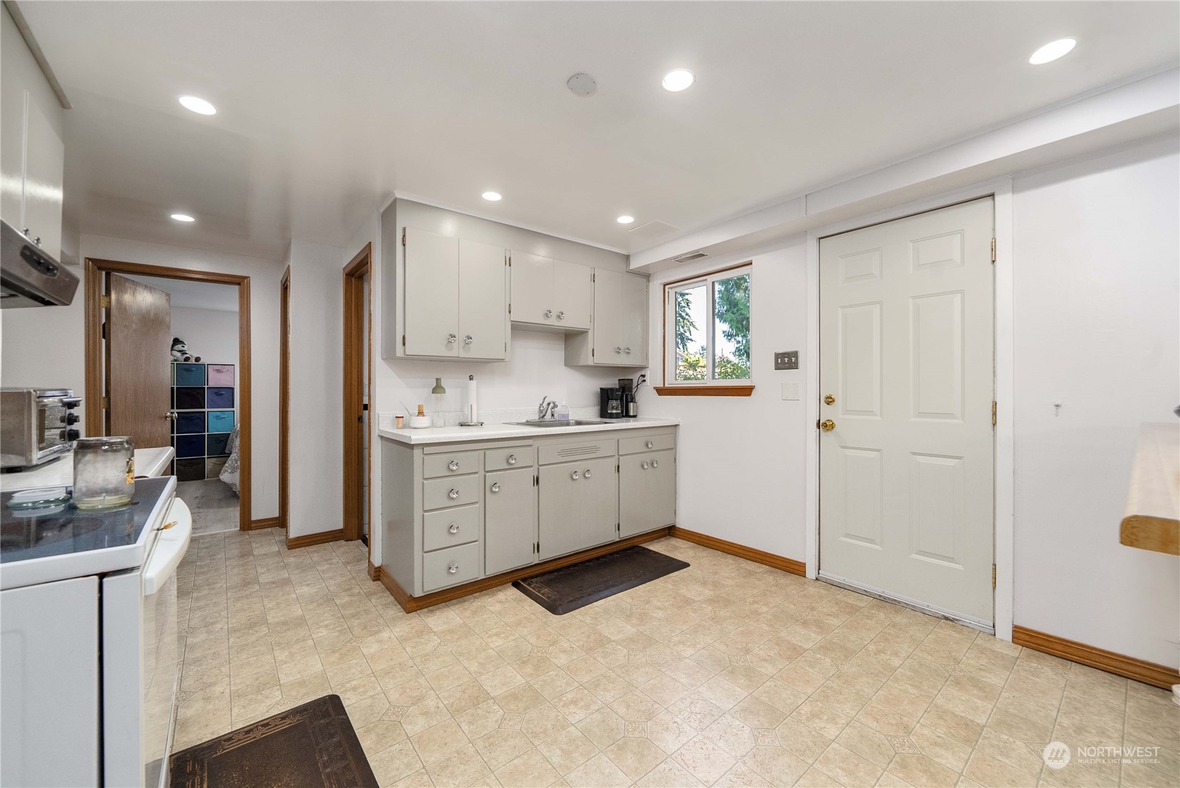7211 Beverly Boulevard Everett, WA 98203 - Photo 21 of 36 a kitchen with white cabinets and window