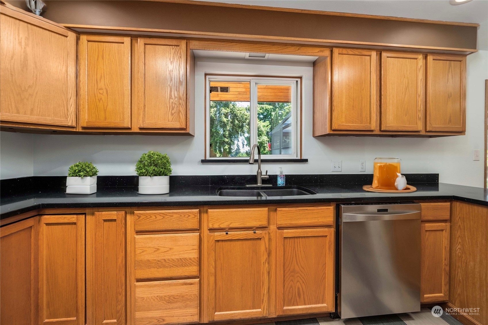 7211 Beverly Boulevard Everett, WA 98203 - Photo 10 of 36 a kitchen with stainless steel appliances granite countertop wooden cabinets a sink and a window