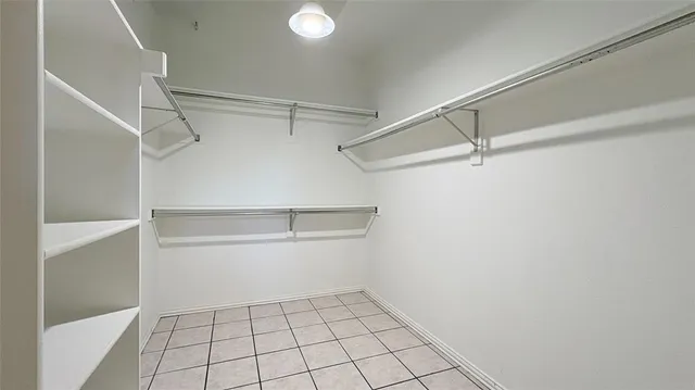 a room with a bed and a chandelier