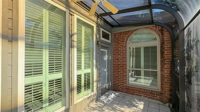 a front view of a house with garden and trees
