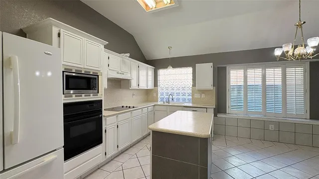 a kitchen with stainless steel appliances a refrigerator and a stove top oven