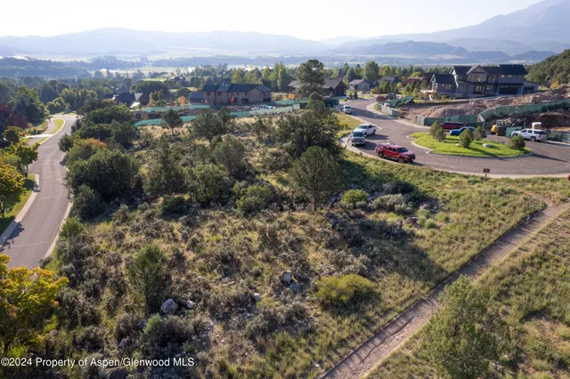 an aerial view of a houses with a swimming pool