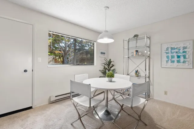 a view of a dining room with furniture a chandelier and wooden floor